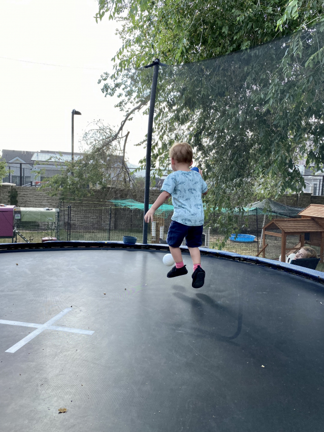 Toddler jumping on a trampoline