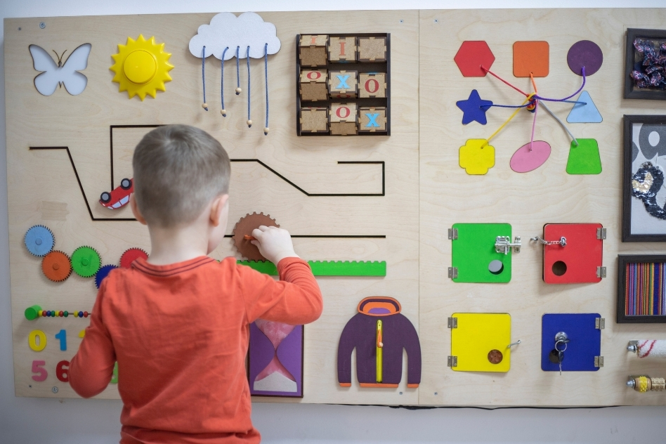 Child using busy board