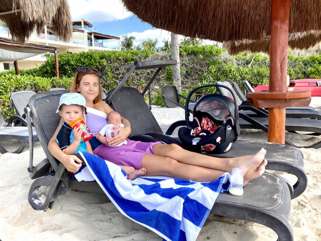 Toddler and newborn at the beach with Cybex Cloud Q car seat