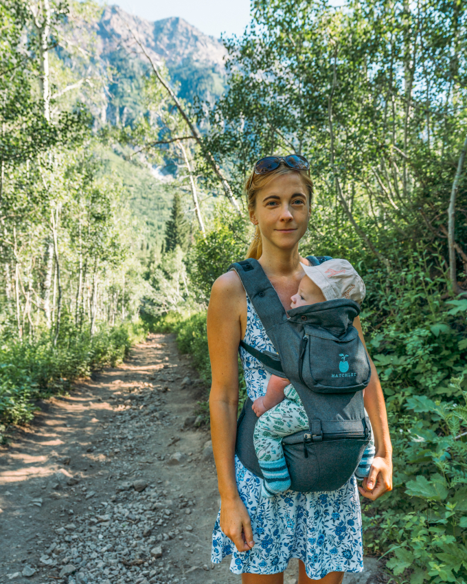 Child in back facing baby carrier.