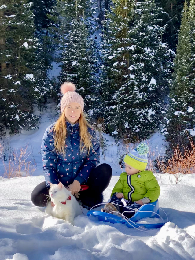 Cat and toddler sledding in Utah