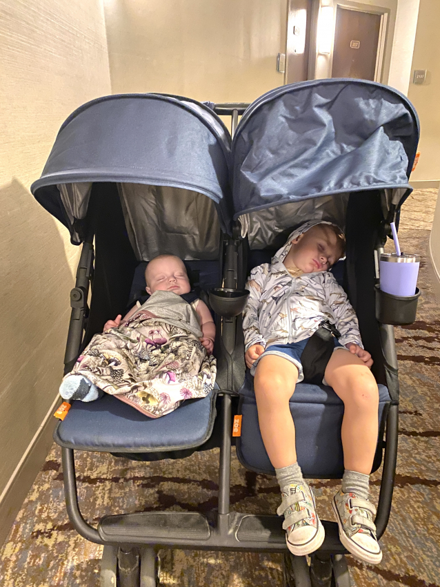 Children sleeping in a double travel stroller