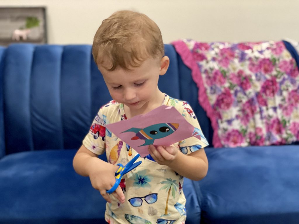 Child using safest toy scissors.