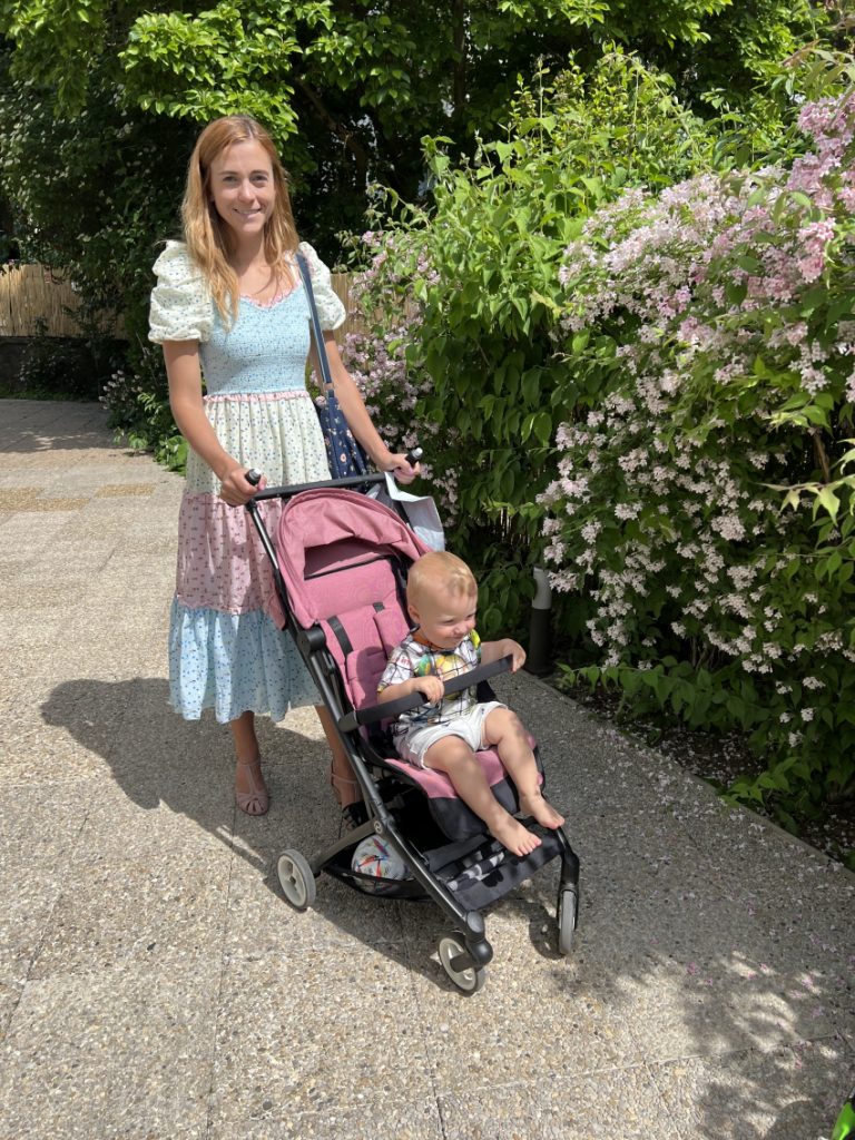 Baby holding onto a bumper bar on Cybex Libelle stroller