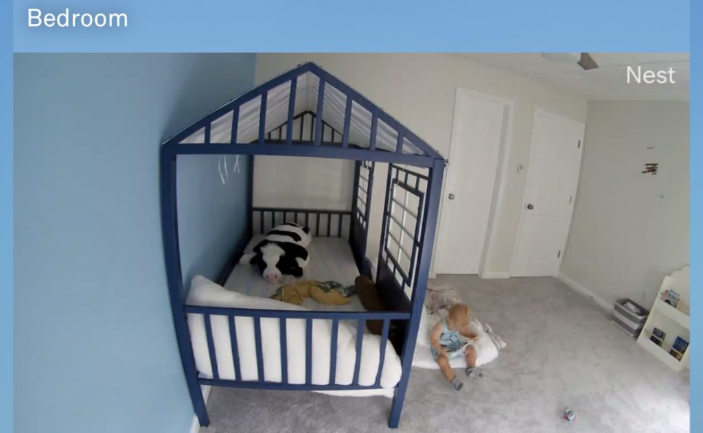 View from Nest camera of child playing next to montessori floor bed.