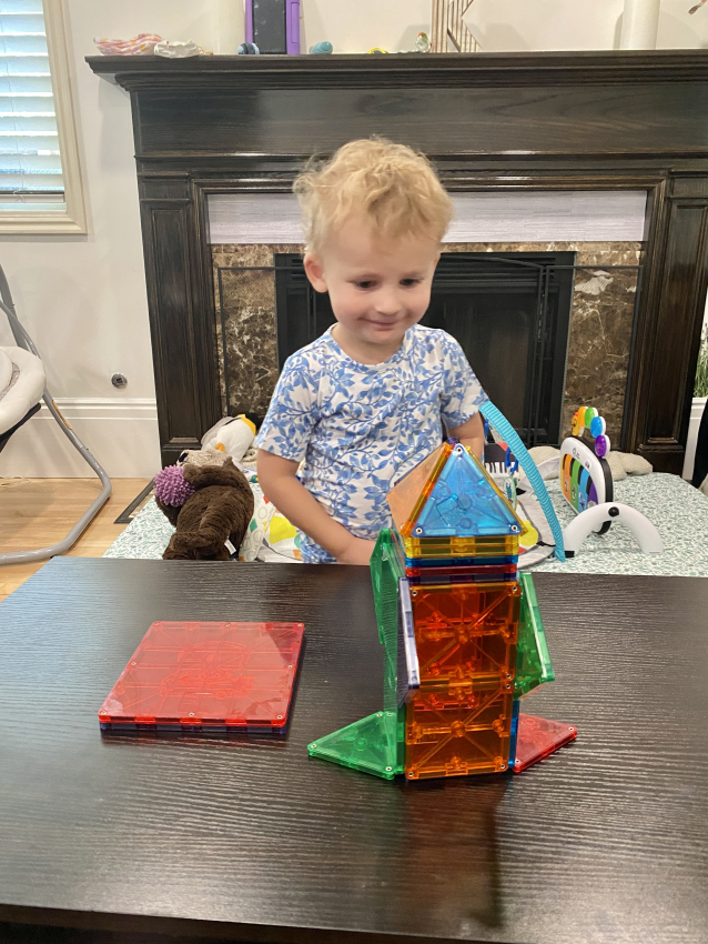 Toddler playing with Magna Tiles