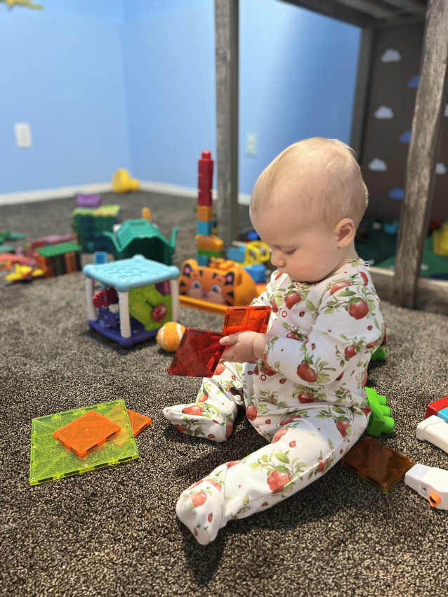Baby playing with magnetic tiles