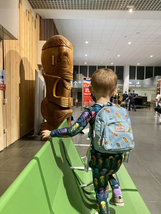 Toddler backpack for travel. Toddler waiting at the airport with his backpack.