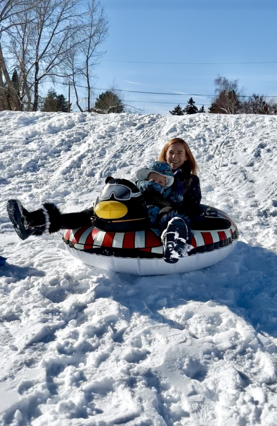 Toddler sleds with parent and child
