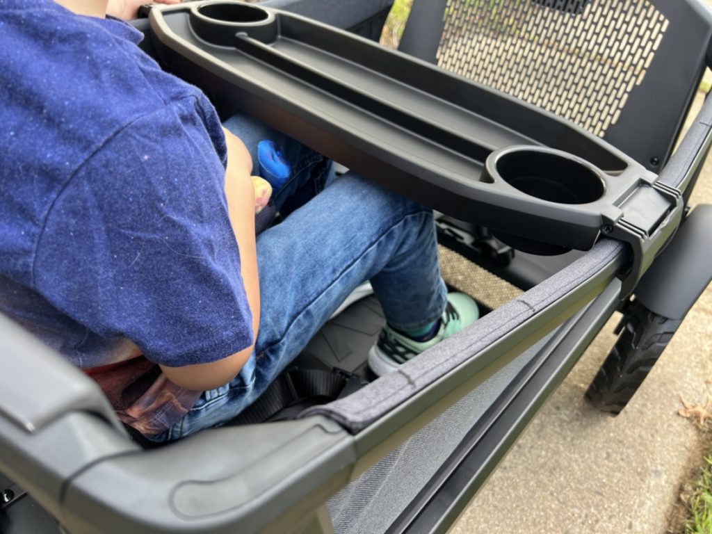 Preschooler sitting in a Veer cruise wagon stroller