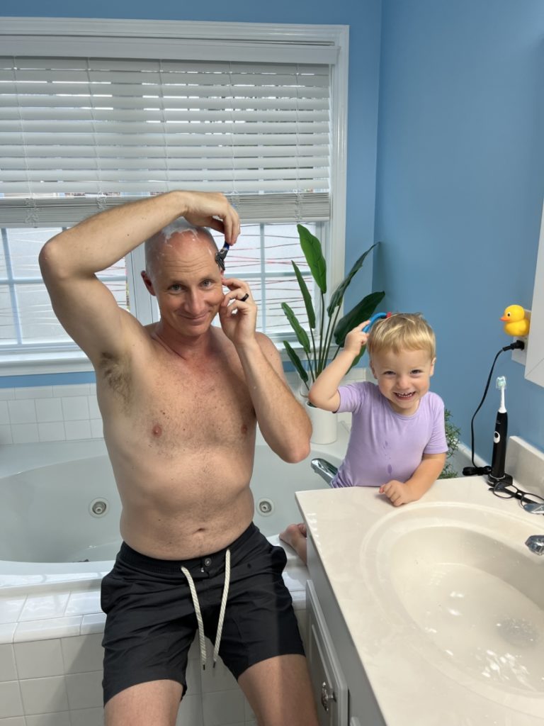 Dad shaving with son using pretend shaving kit