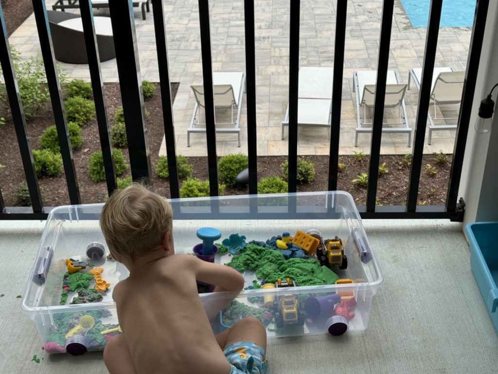 Toddler playing with kinetic sand